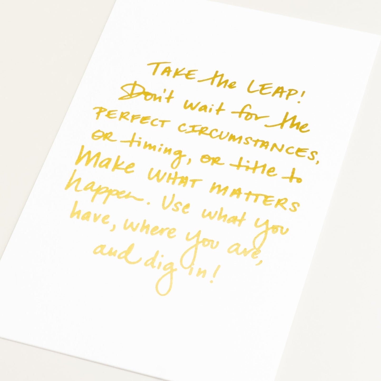Art Print with gold lettering and white background on an angle